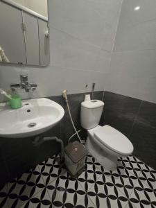 a bathroom with a white toilet and a sink at Gia An Hotel in Hanoi