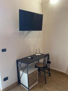 a black desk with a chair and a lamp at Tenuta Lanza Il Mulino in Acquaviva Platani