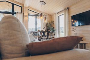 a living room with a couch and a table with chairs at Resort Wilsumer Berge in Wilsum