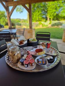 a tray of food on a table with food on it at Le Bos Dordogne in Soulaures