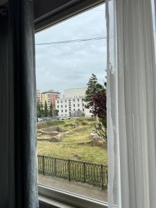 a window with a view of a building at Forum View 2 in Durrës