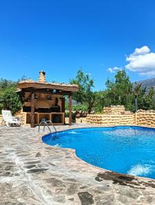 a swimming pool with a gazebo next to a resort at Casas Amaro in Órgiva