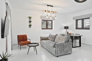 a living room with a couch and a table at Lambda Luxury Villa 2 in Syvota