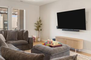 a living room with two couches and a flat screen tv at Weekend Vibes townhouse in St. George +69 photos