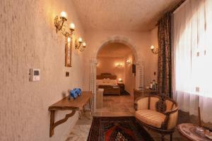 a hallway with a room with a bed and a table at Hasan Bey Konakları in Avanos