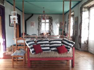 a living room with a couch with pillows on it at Quinta Maravista in Faial da Terra