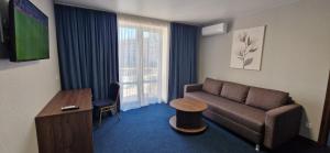 a living room with a couch and a table at Kozatskiy Hotel in Kyiv