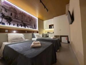 a room with two beds with towels on them at Studios 138 in Belém +11 photos