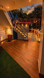 an outdoor deck with a staircase and a stair case at Tree Heaven Resort-Kanatal in Kanatal