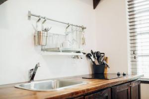 a kitchen with a sink and a wooden counter top at Vive Zen Queen Room in Miami +22 photos