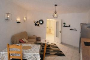 a living room with a couch and a table at Charming accommodation for 2 people in ELNE in Elne