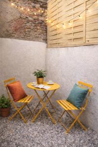 a yellow table and two chairs with a table and a table and chairs with at Charming accommodation for 2 people in ELNE in Elne