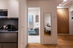 a bathroom with a sink and a mirror in a room at GL Suite Via Baglioni in Perugia +10 photos