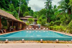 a swimming pool in front of a villa at Lihim Resorts in El Nido