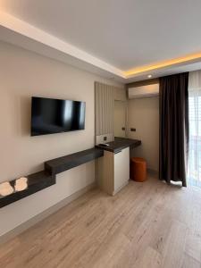 ein Zimmer mit einem Flachbildfernseher an der Wand in der Unterkunft Kayalar Hotel in Antalya