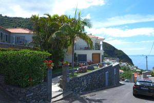 a house on the side of a hill at Ocean escape with private pool in Arco da Calheta
