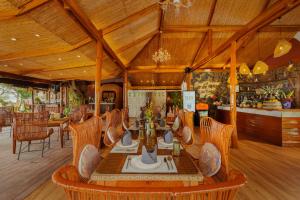 a dining room with a table and chairs at Lihim Resorts in El Nido