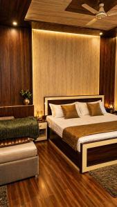 a bedroom with a large bed and a couch at Tree Heaven Resort-Kanatal in Kanatal +50 photos