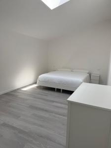 a bedroom with a bed in a white room at Country Escape in Poggio Renatico +2 photos