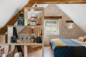 a room with a bed and a shelf in a attic at La Lizardiere des Landes in La Flèche +16 photos