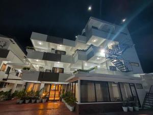 a large white building with a fire escape at ZKB Twins Hotel in General Santos