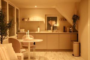 a kitchen with a table and a dining room at Breeze Inn B&B in Oegstgeest