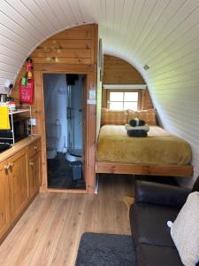 a bedroom with a bed in a small room at Acorns Luxury Glamping in Holywell