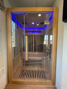 a large wooden cage with blue lights on it at Tinyhaushotel - Campingpark Nabburg in Nabburg