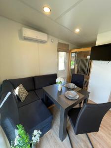 a living room with a couch and a table at Tinyhaushotel - Campingpark Nabburg in Nabburg