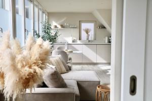 a living room with a couch and a table at Breeze Inn B&B in Oegstgeest +69 photos