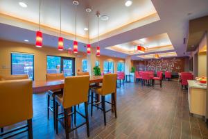 a dining room with a long table and chairs at TownePlace Suites by Marriott Newnan in Newnan