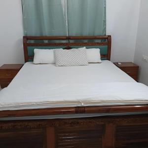 a bed with two pillows on top of it at Shivoham holiday villa in Dapoli +7 photos