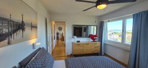 a bedroom with a bed and a dresser and a window at Lake View See & Bergsicht free parking in Kreuzlingen