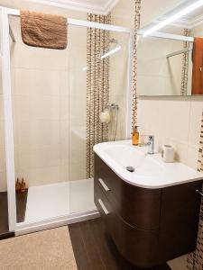 a bathroom with a sink and a shower at Baleal Breeze Apartment in Ferrel