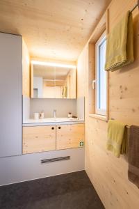 a bathroom with a sink and a mirror at Tiny Bishorn mit privatem Whirlpool in Grächen +42 photos