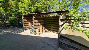 ein Holzschuppen mit einem Holzstapel in der Unterkunft De Kansel in Nieuw-Dordrecht