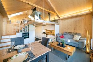 a living room with a couch and a table at Tiny Bishorn mit privatem Whirlpool in Grächen