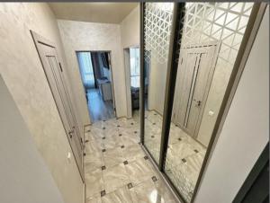 a reflection of a hallway in a mirror in a house at Апартаменти в ЦЕНТРІ ІМПЕРІАЛ in Truskavets +17 photos