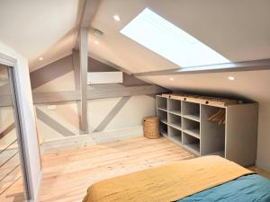 a attic bedroom with a skylight and a bed at cabane perche duplex st affrique in Saint-Affrique