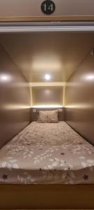 a small bed in a small room with at CaiPods Backpacker Hostel by G10 Guest House Bandung in Bandung