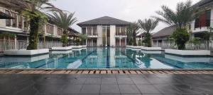 a swimming pool in the middle of a building at CaiPods Backpacker Hostel by G10 Guest House Bandung in Bandung +14 photos
