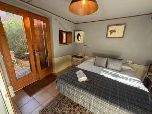 a bedroom with a bed with a book on it at Cabane Du Cerf in Llivia