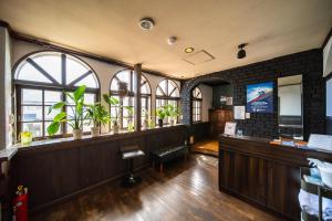 a restaurant with a waiting area with windows at The Bears Lodge in Hakuba