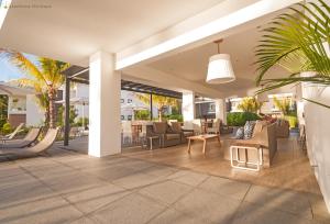 an outdoor patio with chairs and a table at Latitude - with private plunge pool in Rivière Noire