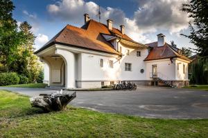 a large white building with a brown roof at Vila Háj in Úsov