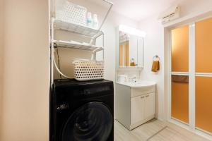 a washing machine in a bathroom with a sink at Anecis笠取町2 in Nagoya +36 photos