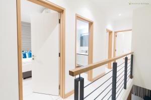 a staircase in a house with a pivot door at Latitude - with private plunge pool in Rivière Noire