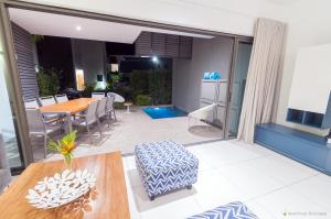 a living room with a table and a dining room at Latitude - with private plunge pool in Rivière Noire