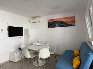 a living room with a blue couch and a table at Holiday Park Mimoza in Bašanija