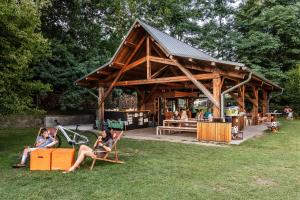 a group of people sitting in chairs in front of a pavilion at Vila Háj in Úsov